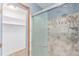 Tiled shower with a sliding glass door and metal fixtures at 3780 E 117Th Ave, Thornton, CO 80233