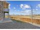 Exterior home view featuring a large backyard, patio, and open space at 17097 W 87Th Ave, Arvada, CO 80007