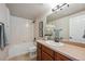 Tiled bathroom featuring a vanity, shower-tub combination, and modern fixtures at 17097 W 87Th Ave, Arvada, CO 80007