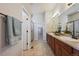 Elegant bathroom with double vanity, tile flooring, and a glass-enclosed shower at 17097 W 87Th Ave, Arvada, CO 80007