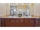 Well-lit bathroom featuring double sinks, stylish fixtures, and a large mirror at 17097 W 87Th Ave, Arvada, CO 80007