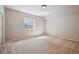 This carpeted bedroom is bright and features a window with a view at 17097 W 87Th Ave, Arvada, CO 80007