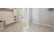 Organized walk-in closet featuring custom shelving, drawers, and neutral-toned hexagon flooring at 17097 W 87Th Ave, Arvada, CO 80007
