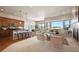 Open-concept living room featuring a modern kitchen, hardwood floors, and large windows at 17097 W 87Th Ave, Arvada, CO 80007