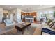 Open-concept living room featuring a modern kitchen, hardwood floors, and stylish furnishings at 17097 W 87Th Ave, Arvada, CO 80007