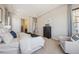 Spacious main bedroom with tray ceilings, ensuite bathroom, and a comfortable sitting area at 17097 W 87Th Ave, Arvada, CO 80007