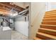 Unfinished basement with stairs, laundry, furnace, and exposed ceiling at 2062 S Helena St # B, Aurora, CO 80013