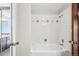 Bathroom featuring a tub with shower, decorative tile accents, and a vanity at 2062 S Helena St # B, Aurora, CO 80013