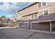 Multi-story townhome with brown siding, garage doors and well manicured landscaping at 2062 S Helena St # B, Aurora, CO 80013