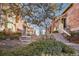 Community featuring townhomes with brick chimneys, landscaping, and inviting pathways at 2062 S Helena St # B, Aurora, CO 80013