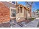 Close up exterior view of a townhouse's front porch with brown siding and cream painted railings at 2062 S Helena St # B, Aurora, CO 80013