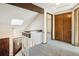 Hallway with natural lighting and skylight, carpet, doors to rooms, and decorative wooden beams at 2062 S Helena St # B, Aurora, CO 80013