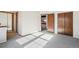Spacious hallway with large windows, natural lighting, and doors to rooms and closets at 2062 S Helena St # B, Aurora, CO 80013