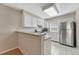 Bright kitchen featuring white cabinets, granite countertops, and stainless steel appliances at 2062 S Helena St # B, Aurora, CO 80013