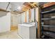 Unfinished laundry room in the basement with white washer and dryer at 2062 S Helena St # B, Aurora, CO 80013