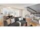 Bright living room featuring an open floor plan, hardwood floors, and staircase at 2062 S Helena St # B, Aurora, CO 80013