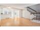 Spacious living room with hardwood floors, a staircase, and an open layout at 2062 S Helena St # B, Aurora, CO 80013