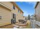 Exterior view of a backyard with brick patio, grill, seating, and a glimpse of neighboring homes at 23601 E Mississippi Cir, Aurora, CO 80018