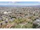 Aerial view of home in established neighborhood with mature trees, landscaping and walking path at 6609 W Mexico Pl, Lakewood, CO 80232