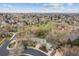 Aerial view of property and surrounding neighborhood featuring mature trees and landscaping at 6609 W Mexico Pl, Lakewood, CO 80232