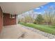Covered back patio area overlooking a lush green yard and mature trees at 6609 W Mexico Pl, Lakewood, CO 80232