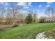 A spacious lawn area in the backyard, with a chain link fence bordering the property at 6609 W Mexico Pl, Lakewood, CO 80232
