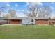 Home exterior features a well-maintained lawn, with a brick and siding exterior at 6609 W Mexico Pl, Lakewood, CO 80232