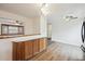 Dining area showcasing wood cabinets, stylish lighting, and wood floors at 6609 W Mexico Pl, Lakewood, CO 80232