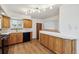 Updated kitchen featuring wood cabinets, subway tile backsplash, and sleek countertops at 6609 W Mexico Pl, Lakewood, CO 80232