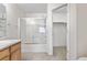 Clean bathroom featuring a shower-tub combo and a walk-in closet at 18897 E Linvale Pl, Aurora, CO 80013