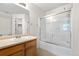 Bright bathroom with a shower-tub combo and oak vanity at 18897 E Linvale Pl, Aurora, CO 80013