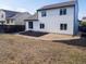 Backyard of a two-story home featuring a small patio and grass area with black mulch beds at 14608 E 52Nd Ave, Denver, CO 80239