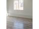 Bright bedroom with a window overlooking the fenced backyard at 14608 E 52Nd Ave, Denver, CO 80239