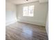 Cozy bedroom featuring light hardwood floors and a window at 14608 E 52Nd Ave, Denver, CO 80239