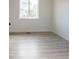 Cozy bedroom featuring light hardwood floors and a window at 14608 E 52Nd Ave, Denver, CO 80239
