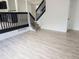 Entryway with a view of staircase and a modern kitchen featuring dark cabinets and stainless steel appliances at 14608 E 52Nd Ave, Denver, CO 80239