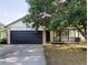 Charming single-story home with a dark two-car garage and a welcoming front porch at 14608 E 52Nd Ave, Denver, CO 80239