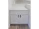Hallway nook featuring white cabinets with dark hardware and a light-colored countertop at 14608 E 52Nd Ave, Denver, CO 80239