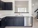 Contemporary kitchen with a stainless steel dishwasher, gold faucet and dark cabinets at 14608 E 52Nd Ave, Denver, CO 80239