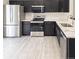 Modern kitchen featuring stainless steel appliances, dark cabinets, quartz countertops and gold hardware at 14608 E 52Nd Ave, Denver, CO 80239
