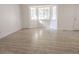 Inviting living room featuring a large bay window and stylish, light-colored wood floors at 14608 E 52Nd Ave, Denver, CO 80239
