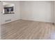 Bright living room with wood floors and a view of the modern kitchen at 14608 E 52Nd Ave, Denver, CO 80239