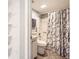 Compact bathroom featuring tile floors, a shower with marble curtain, and built-in shelving at 2201 Sable Blvd # 1008, Aurora, CO 80011