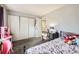 bedroom featuring a comfortable bed, desk, and ample closet space at 2201 Sable Blvd # 1008, Aurora, CO 80011