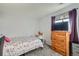 Bright bedroom with a large window, dresser, and cozy decor at 2201 Sable Blvd # 1008, Aurora, CO 80011