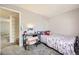 Bedroom featuring a comfortable bed, a stylish desk, and a closet for storage at 2201 Sable Blvd # 1008, Aurora, CO 80011