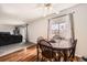 Cozy dining area featuring wood floors, a ceiling fan, and a view to the living room at 2201 Sable Blvd # 1008, Aurora, CO 80011