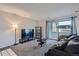 Inviting living room with a TV, comfortable seating, and access to a balcony at 2201 Sable Blvd # 1008, Aurora, CO 80011