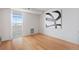 Bedroom featuring hardwood floors, white walls, modern artwork and access to a balcony at 1313 N Williams St # 1103, Denver, CO 80218