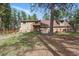 A backyard view features a patio, wooden fence and mature landscaping surrounding the home at 17720 Canterbury Dr, Monument, CO 80132